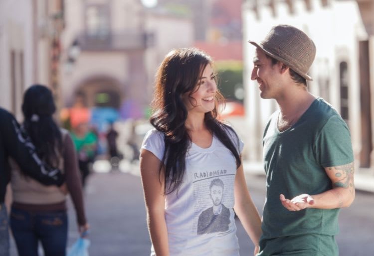 A young man flirts with a pretty young girl